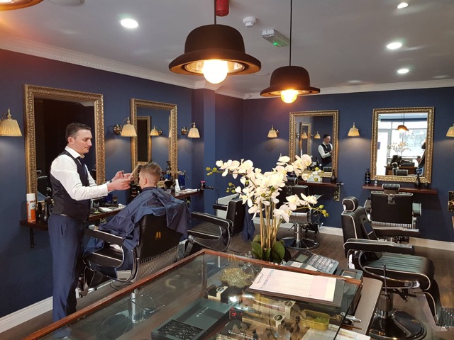 Owner of Mens Grooming Terenure cutting a young mans hair